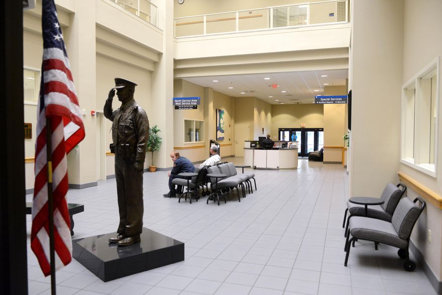 This March 11, 2014 photo shows The Grand Rapids police station lobby in Grand Rapids, Mich. Grand Rapids plans a $345,000 renovation to its police station lobby that will address long-held security concerns and restrict public access inside the department's headquarters. Capt. David Kiddle says that security at the Monroe Center headquarters was set before the Sept. 11, 2001 terrorist attacks. The facility opened before the attacks. It doesn't have a secure lobby and one entrance was shut to boost security. Under the new plans, officers would sit behind bullet-resistant glass. A staircase and elevator leading to offices wouldn't be accessible to the public. (AP Photo/The Grand Rapids Press, Emily Rose Bennett) ALL LOCAL TV OUT; LOCAL TV INTERNET OUT