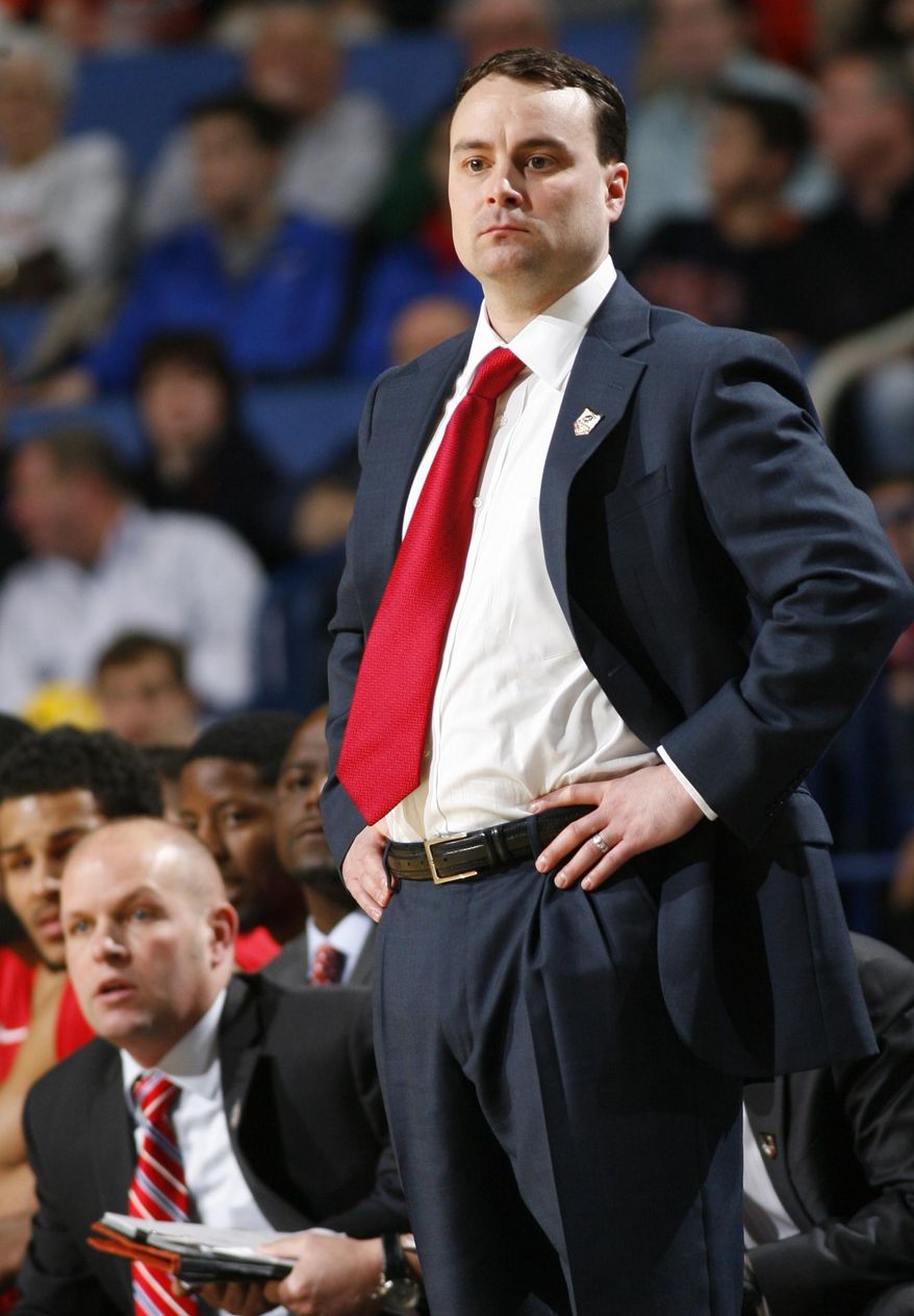 Dayton head coach Archie Miller watches his team play during the first half of a second-round game against Ohio State in the NCAA college basketball tournament in Buffalo, N.Y., Thursday, March 20, 2014. (AP Photo/Bill Wippert)