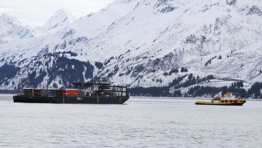 In this photo taken Feb. 26, 2014, is a tug pulling an Alyeska Pipeline SERVS (Ship Escort and Response Vessel System) barge through the port of Valdez in an oil response drill in Valdez, Alaska. The company conducts two major spill drills a year after the Exxon Valdez ran aground in March 1989, spilling nearly 11 million gallons of crude in Prince William Sound. (AP Photo/Mark Thiessen)