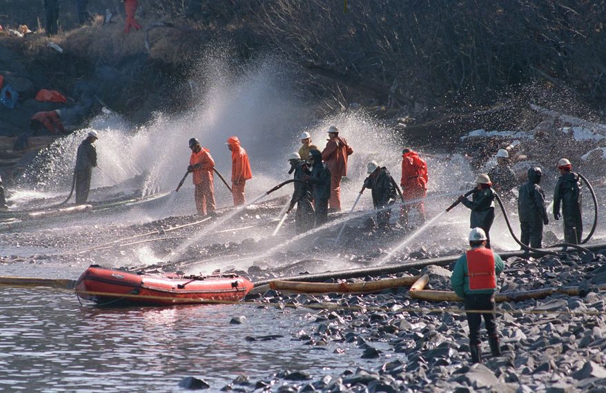 In this April 21, 1989 file photo, crews use high pressured hoses to blast the rocks on this beach front on Naked Island, Alaska. This is one of only two beaches that are being worked on, of the 58 beaches in the Prince William Sound. On March 24, the crude oil tanker Exxon Valdez grounded on a reef and spilled nearly 11 million gallons of oil in the waters. Nearly 25 years after the Exxon Valdez oil spill off the coast of Alaska, some damage heals, some effects linger in Prince William Sound. (AP Photo/Rob Stapleton, File)