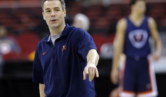Virginia head coach Tony Bennett directs his team during practice at the NCAA college basketball tournament in Raleigh, N.C., Thursday, March 20, 2014. Virginia plays Coastal Carolina in a second-round game on Friday. (AP Photo/Gerry Broome)