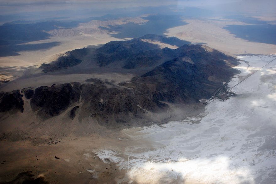 In this February 2014 aerial photo, the white-colored Soda Lake is visible in the Mojave National Preserve in San Bernardio County, Calif. A commercial solar project is proposed within a mile of the lake bed, prompting worries about water depletion and the fate of an endangered fish, among other concerns. (AP Photo/The Press-Enterprise, Kurt Miller) MAGS OUT; MANDATORY CREDIT
