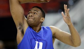 Duke&#39;s Jabari Parker goes up to dunk during practice at the NCAA college basketball tournament in Raleigh, N.C., Thursday, March 20, 2014. Duke plays Mercer in a second-round game on Friday. (AP Photo/Gerry Broome)