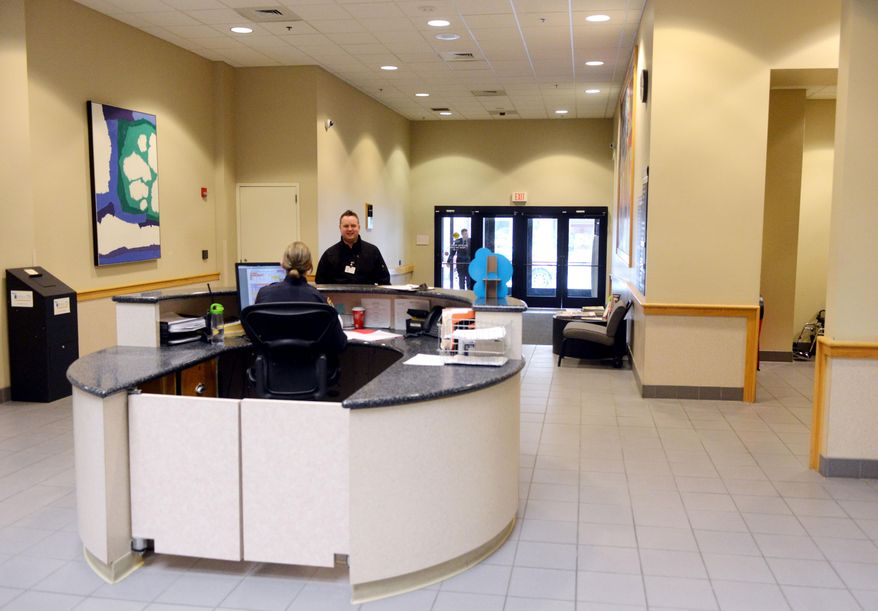 This March 11, 2014 photo shows The Grand Rapids police station lobby in Grand Rapids, Mich. Grand Rapids plans a $345,000 renovation to its police station lobby that will address long-held security concerns and restrict public access inside the department's headquarters. Capt. David Kiddle says that security at the Monroe Center headquarters was set before the Sept. 11, 2001 terrorist attacks. The facility opened before the attacks. It doesn't have a secure lobby and one entrance was shut to boost security. Under the new plans, officers would sit behind bullet-resistant glass. A staircase and elevator leading to offices wouldn't be accessible to the public. (AP Photo/The Grand Rapids Press, Emily Rose Bennett) ALL LOCAL TV OUT; LOCAL TV INTERNET OUT