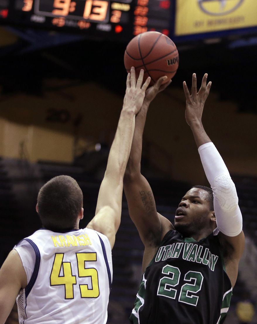 Utah Valley's Chad Ross, right, shoots against California's David Kravish (45) in the first half of an NCAA college basketball game Wednesday, March 19, 2014, in Berkeley, Calif. (AP Photo/Ben Margot)