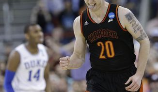 Mercer forward Jakob Gollon (20) celebrates a basket against Duke during the first half of a second-round game in the NCAA college basketball tournament, Friday, March 21, 2014, in Raleigh, N.C. (AP Photo/Gerry Broome)