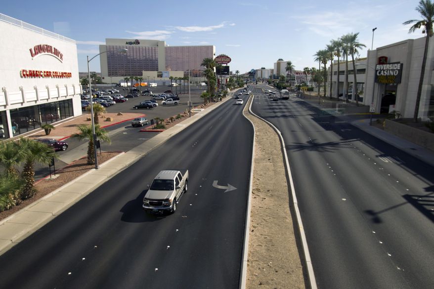 This Sept. 9, 2012 photo shows a view of Casino Drive looking southbound in Laughlin, Nev. Laughlin, an unincorporated town of 7,300, is about 100 miles south of Las Vegas and popular with bargain-hunting retirees who drive in for sometimes months-long getaways to the region. The town, with nine casino-resorts clustered along the banks of the Colorado River, lured 2 million visitors last year and generated $455 million in gambling revenue. But tourism, the only major industry in Laughlin, has been declining for years, even as Las Vegas bounces back and Mesquite, another small resort destination in the region, stabilized. Laughlin’s annual visitor volume has fallen 60 percent from 5 million about 15 years ago. Gambling revenue rose to $631 million in 2007 but has dropped every year since. (AP Photo/ Las Vegas Sun, Steve Marcus)