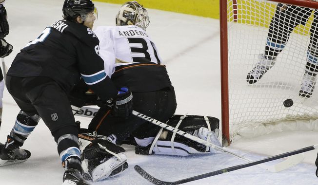 Anaheim Ducks goalie Frederik Andersen, right, of Denmark, is beaten for a goal on a shot by San Jose Sharks&#x27; Patrick Marleau as center Joe Pavelski, left, watches during the first period of an NHL hockey game on Thursday, March 20, 2014, in San Jose, Calif. (AP Photo/Marcio Jose Sanchez)