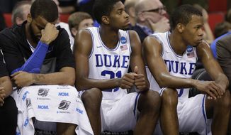 Duke&#39;s Josh Hairston, Amile Jefferson and Rodney Hood sit on the bench during the second half of an NCAA college basketball second-round game against Mercer, Friday, March 21, 2014, in Raleigh, N.C. Mercer won 78-71. (AP Photo/Chuck Burton)