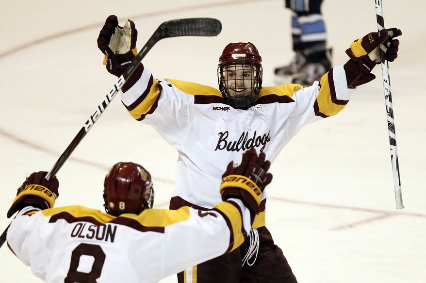 Minnesota-Duluth's Caleb Herbert, top, celebrates his goal with teammate Drew Olson (8) during the second period of a NCAA Northeast Regional college hockey game against Maine in Worcester, Mass., Saturday, March 24, 2012. (AP Photo/Winslow Townson)