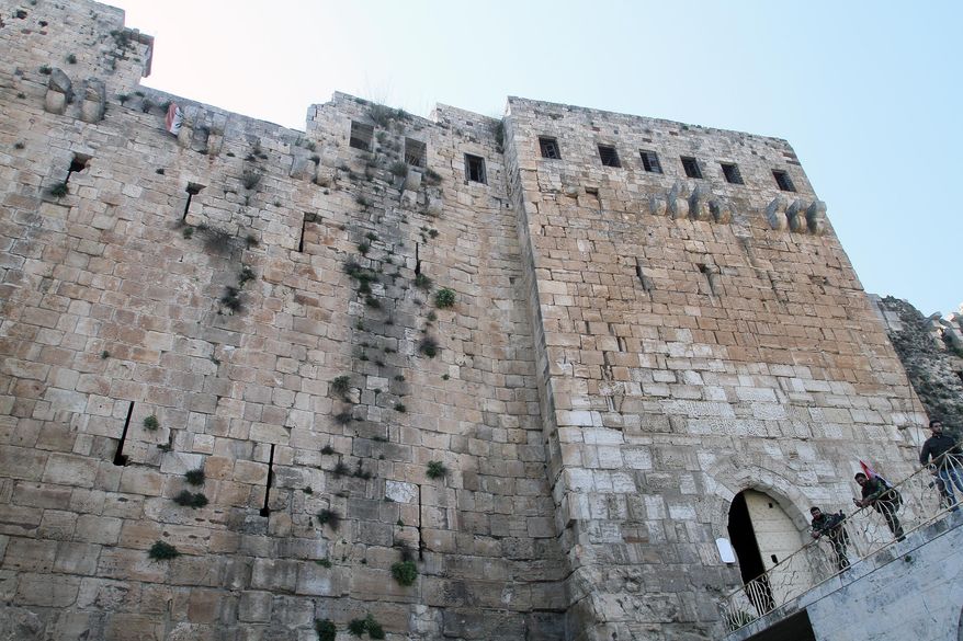 Syrian troops stand by the Crac des Chevaliers as they take reporters on a tour a day after Syrian troops ousted rebels from the castle located near the village of Hosn, Syria, Friday, March 21, 2014. The Syrian army ousted rebels from the massive Crusader fortress after several hours of fierce fighting, killing at least 93 of them as they fled to neighboring Lebanon, an army commander told reporters on a government-led tour of the area Friday. (AP Photo)