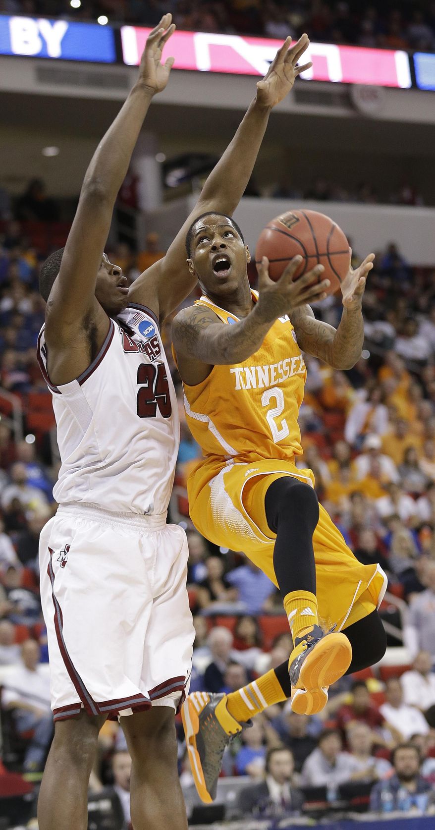 Tennessee guard Antonio Barton (2) shoots over Massachusetts' Cady Lalanne during the first half of an NCAA college basketball second-round tournament game, Friday, March 21, 2014, in Raleigh, N.C. (AP Photo/Gerry Broome)