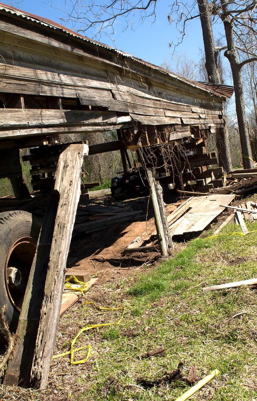 A 25-foot-wide, 50-foot-long wooden rectangle building that faces the Brazos River, sits in a small, four-house neighborhood established in 1846. Originally a post office, the building has been used for purposes other than what was intended for it, including at various times a bar and grocery store. The building has been gutted and currently has no walls, with the trussed, metal roof held up by construction equipment to allow workers to repair the foundation. (AP Photo/The Brazosport Facts, Kellie Marriot)