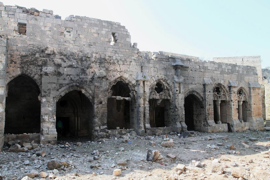 Damages are seen at the Crac des Chevaliers as Syrian troops take reporters on a tour a day after Syrian troops ousted rebels from the castle located near the village of Hosn, Syria, Friday, March 21, 2014. The Syrian army ousted rebels from the massive Crusader fortress after several hours of fierce fighting, killing at least 93 of them as they fled to neighboring Lebanon, an army commander told reporters on a government-led tour of the area Friday. (AP Photo)