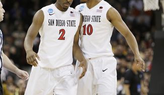 San Diego State’s Xavier Thames (2) and Aqeel Quinn (10) react after a basket by teammate Xavier Thames in the first half during the third-round game of the NCAA men&#39;s college basketball tournament against North Dakota State in Spokane, Wash., Saturday, March 22, 2014. (AP Photo/Young Kwak)