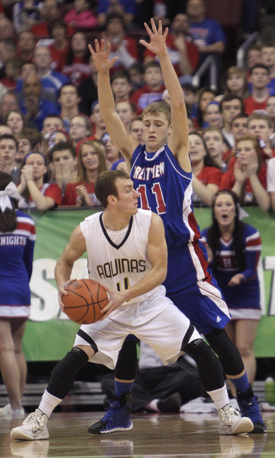 Louisville Aquinas' Sam Pusateri, front, looks for an open pass as Convoy Crestview's Connor Lautzenheiser defends during the first quarter of the OHSAA Division IV boys' high school basketball championship game Saturday, March 22, 2014, in Columbus, Ohio. (AP Photo/Jay LaPrete)