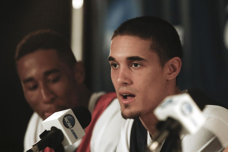 Arizona guard Nick Johnson, flanked by forward Rondae Hollis-Jefferson, talks about the teams' upcoming third round game against Gonzaga in the NCAA college basketball tournament at a news conference, Saturday, March 22, 2014, in San Diego. The teams play Sunday. (AP Photo/Lenny Ignelzi)