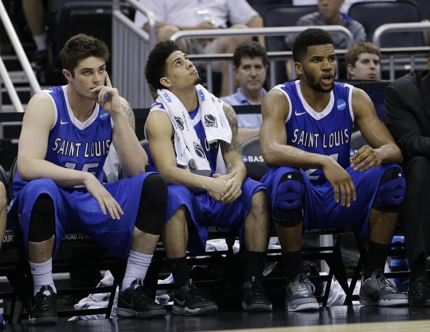 Saint Louis Tanner Lacona, left, Austin McBroom and Dwayne Evans watch from the bench during the second half in a third-round game in the NCAA college basketball tournament against Louisville, Saturday, March 22, 2014, in Orlando, Fla. Louisville defeated Saint Louis 66-51. (AP Photo/John Raoux)