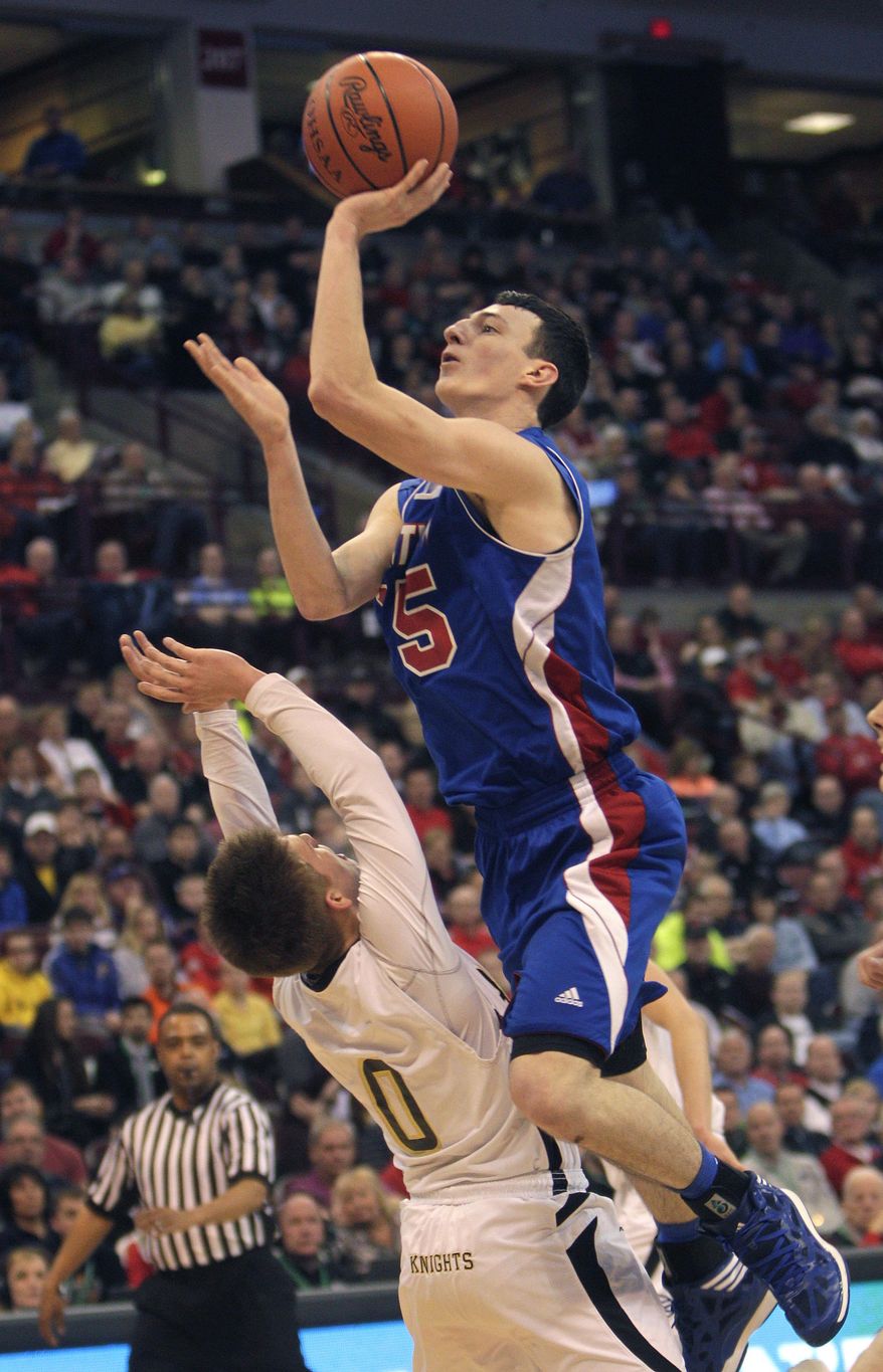 Convoy Crestview's Damian Helm, right, shoots over Louisville Aquinas' Pete Ruthe during the first quarter of the OHSAA Division IV boys' high school basketball championship game Saturday, March 22, 2014, in Columbus, Ohio. (AP Photo/Jay LaPrete)