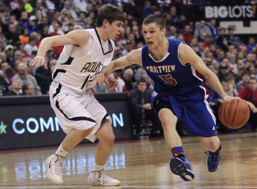 Convoy Crestview's Cam Etzler, right, drives to the basket against Louisville Aquinas' Jacob Paul during the second quarter of the OHSAA Division IV boys' high school basketball championship game Saturday, March 22, 2014, in Columbus, Ohio. (AP Photo/Jay LaPrete)