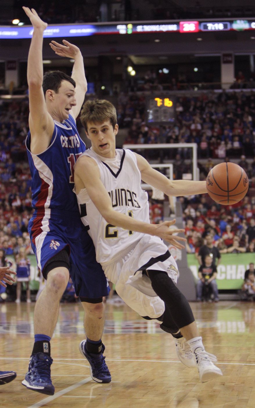 Louisville Aquinas' Austin Hill, right, drives to the basket against Convoy Crestview's Damian Helm during the fourth quarter of the OHSAA Division IV boys' high school basketball championship game Saturday, March 22, 2014, in Columbus, Ohio. Crestview defeated Aquinas 71-44. (AP Photo/Jay LaPrete)