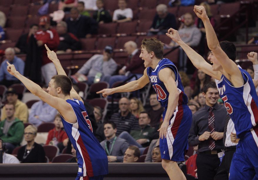 Convoy Crestview's Cam Etzler, left, Brock Rolsten, center, and Damian Helmand celebrate their win over Louisville Aquinas after the OHSAA Division IV boys' high school basketball championship game Saturday, March 22, 2014, in Columbus, Ohio. Crestview defeated Aquinas 71-44. (AP Photo/Jay LaPrete)