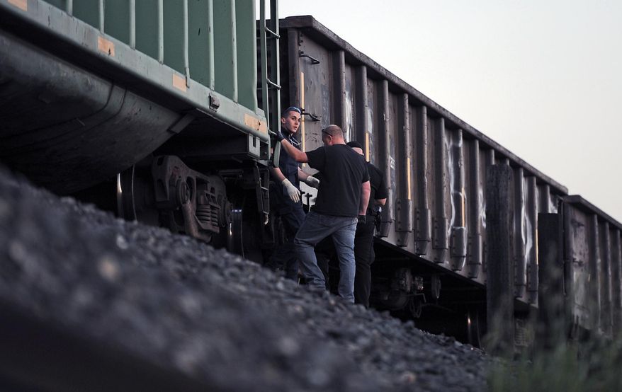 Emergency personnel work at the scene of a train accident where two pedestrians were hit near Earle Yorton Field Friday, March 21, 2014 in Marysville, Calif. (AP Photo/Appeal-Democrat, Chris Kaufman)