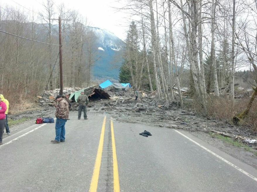 This photo provided by the Washington State Patrol shows the aftermath of a mudslide that moved a house with people inside in Snohomish County on Saturday March 22, 2014. The Washington Department of Transportation says mud, trees and building materials are blocking both directions of State Route 530 near the town of Oso. Search and rescue operations are underway by Snohomish County crews and the Washington State Patrol. Spokesman Bart Treece of the Washington State Department of Transportation says he doesn't know how long the two-lane rural road will be closed. He says drivers are advised to find another way to get between Darrington and Arlington. (AP Photo/Washington State Patrol)