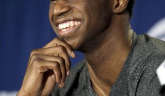 Kansas&#39; Andrew Wiggins laughs at question during a news conference for the third-round game of the NCAA college basketball tournament Saturday, March 22, 2014, in St. Louis. Kansas is scheduled to play Stanford on Sunday. (AP Photo/Jeff Roberson)
