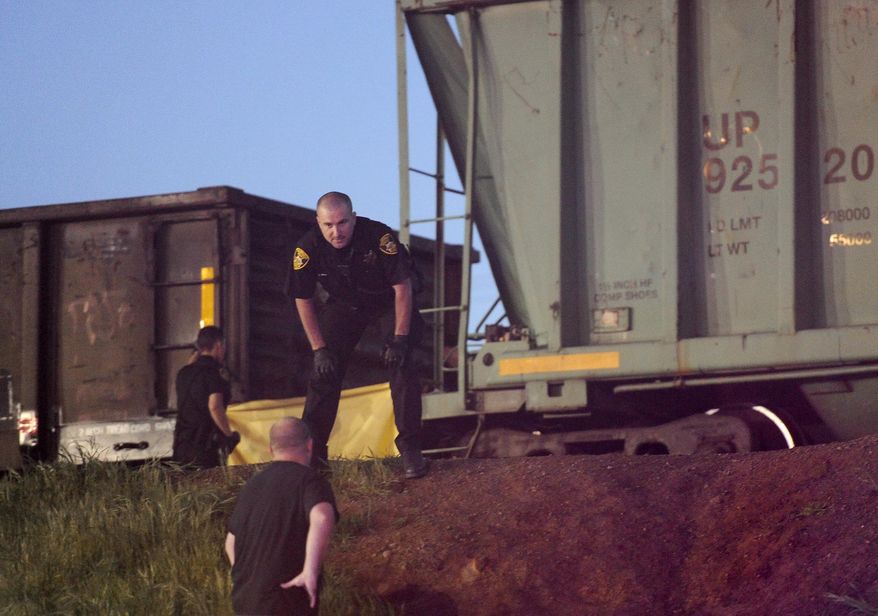 Emergency personnel work at the scene of a train accident where two pedestrians were hit near Earle Yorton Field Friday, March 21, 2014 in Marysville, Calif. (AP Photo/Appeal-Democrat, Chris Kaufman)
