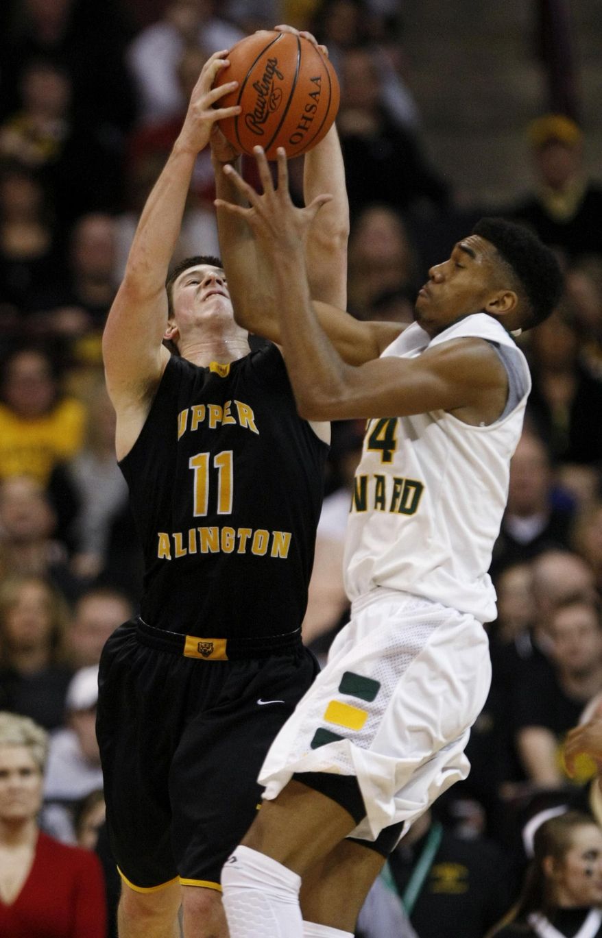 Upper Arlington's Kevin Vannatta, left, works for a pass against Lakewood St. Edward's Mike Ryan during the third quarter of the OHSAA Division I boys' high school basketball championship game in Columbus, Ohio, Saturday, March 22, 2014. St. Edwards won 62-58 in overtime. (AP Photo/Paul Vernon)