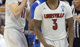 Louisville guard Chris Jones (3) ande forward Luke Hancock (11) reacts to a call during the second half in a third-round game in the NCAA college basketball tournament against Saint Louis,  Saturday, March 22, 2014, in Orlando, Fla. (AP Photo/Phelan M. Ebenhack)