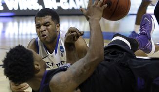 Kansas State&#x27;s Nigel Johnson, front, and Kentucky&#x27;s Andrew Harrison scramble after a loose ball during the second half of a second-round game in the NCAA college basketball tournament Friday, March 21, 2014, in St. Louis. (AP Photo/Jeff Roberson)