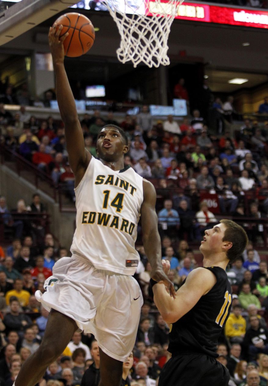 Lakewood St. Edward's Kipper Nichols, left, goes up for a shot against Upper Arlington's Kevin Vannatta during the third quarter of the OHSAA Division I boys' high school basketball championship game in Columbus, Ohio, Saturday, March 22, 2014. St. Edwards won 62-58 in overtime. (AP Photo/Paul Vernon)