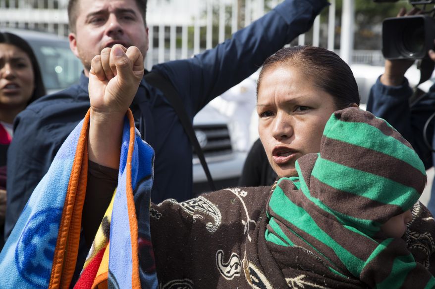 FILE - This March 18, 2014 file photo shows Elvira Arellano waiting to enter into the United States in Tijuana, Mexico. Arellano, a Mexican activist who took sanctuary at a Chicago church for a year to protest her deportation, has returned, Sunday, March 23, 2014. She is protesting the separation of families through deportation. (AP Photo/Alex Cossio, file)