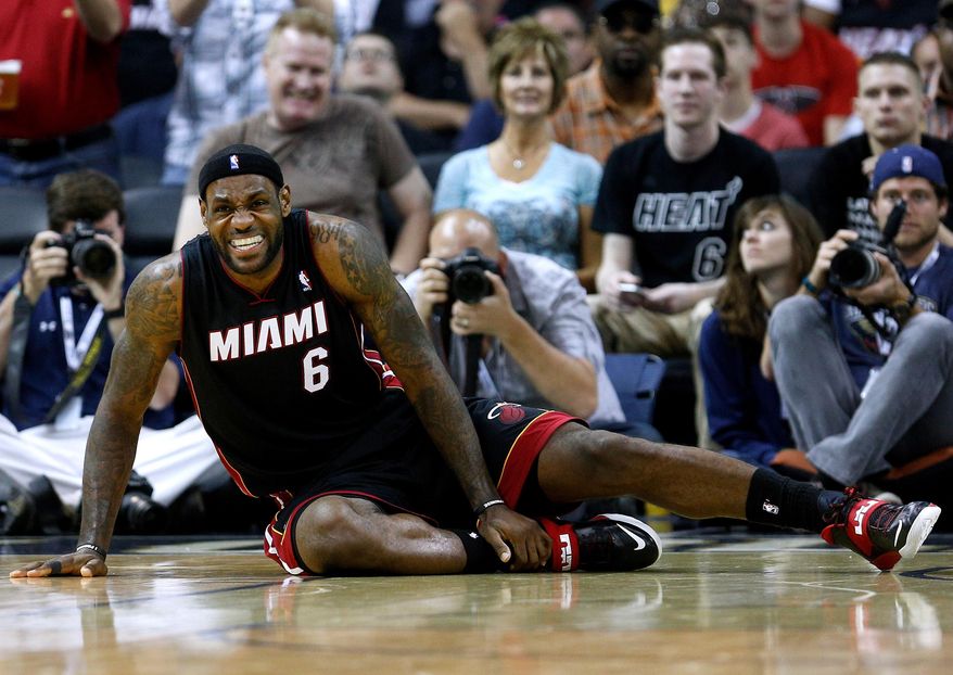 Miami Heat forward LeBron James reacts after falling to the ground during the second half of an NBA basketball game against the New Orleans Pelicans in New Orleans, Saturday, March 22, 2014. The Pelicans won 105-95. (AP Photo/Jonathan Bachman)