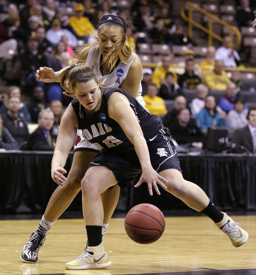 Idaho forward Brooke Reilly grabs a loose ball in front of Louisville guard Antonita Slaughter, rear, during the first half of an NCAA tournament first-round women's college basketball game, Sunday, March 23, 2014, in Iowa City, Iowa. (AP Photo/Charlie Neibergall)