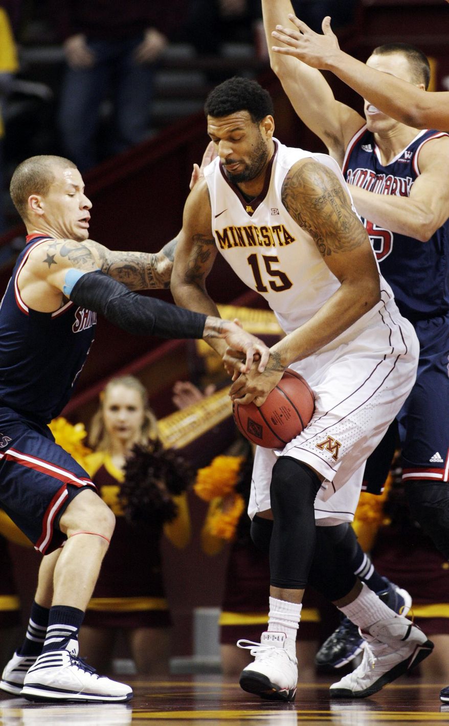 St. Mary's guard Kerry Carter, left, battles for the ball with Minnesota forward Maurice Walker (15) during the first half of an NIT tournament second round game, Sunday, March 23, 2014, in Minneapolis. (AP Photo/Paul Battaglia)