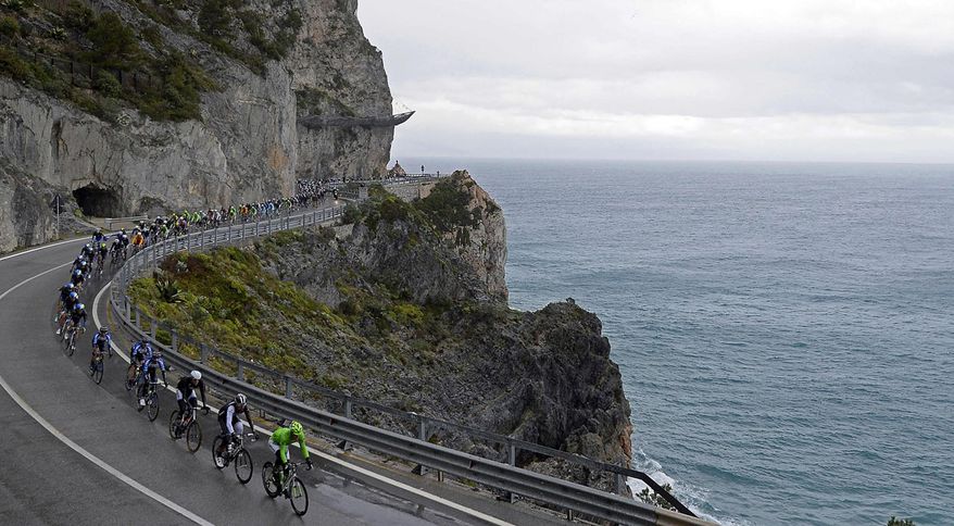 Cyclists ride along the coastline during the Milan-San Remo cycling race, in Sanremo, Italy, Sunday, March 23, 2014. Alexander Kristoff sprinted to victory in the Milan-San Remo classic on Sunday, edging out 2008 winner Fabian Cancellara on a wet and rainy course for the biggest win of his career. Kristoff pulled away in the closing meters to win the 294-kilometer (183 mile) race in 6 hours, 55 minutes, 56 seconds and become the first Norwegian to triumph in the one-day race. (AP Photo/Fabio Ferrari, Lapresse)