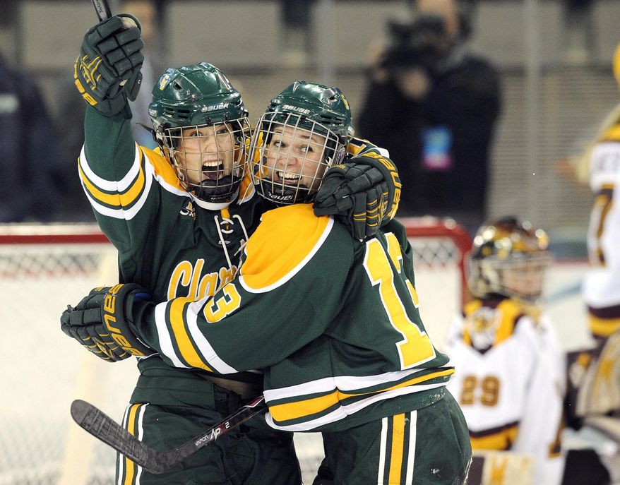 Clarkson's Cayley Mercer, left, and Shelby Nisbet celebrate a goal against Minnesota during the first period an NCAA college hockey game in the finals of the women's Frozen Four in Hamden, Conn., Sunday, March 23, 2014. (AP Photo/Fred Beckham)