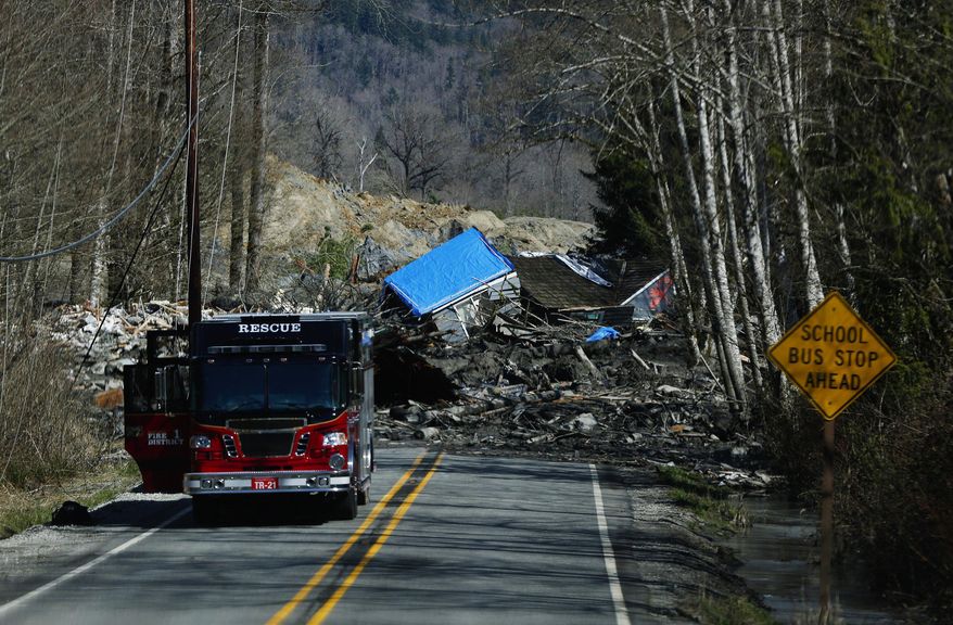 A house is seen destroyed in the mud on Highway 530 next to mile marker 37 on Sunday, March 23, 2014, the day after a giant landslide occurred near mile marker 37 near Oso, Washington. At least six homes have been washed away, with three people reported dead so far and at least eighteen missing. The nearby Stillaguamish River has been dammed up by 15-20 feet of debris as a result, creating more flooding concerns, as reported by KING 5 via the state hydrologist. (AP Photo/The Seattle Times, Lindsey Wasson, Pool)