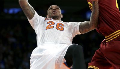 New York Knicks&#39; Shannon Brown, left, puts up a shot while Cleveland Cavaliers&#39; Tyler Zeller defends during the first half of an NBA basketball game at Madison Square Garden, Sunday, March 23, 2014, in New York. (AP Photo/Seth Wenig)