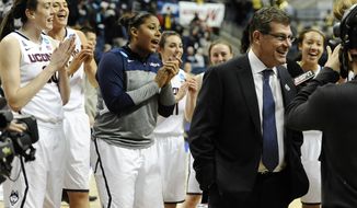The Connecticut team sings Happy Birthday behind head coach Geno Auriemma, right, as he is interviewed on live television after their 87-44 win over Prairie View A&amp;amp;M in a first-round game of the NCAA women&#39;s college basketball tournament, Sunday, March 23, 2014, in Storrs, Conn. Today is Auriemma&#39;s 60th birthday. (AP Photo/Jessica Hill)