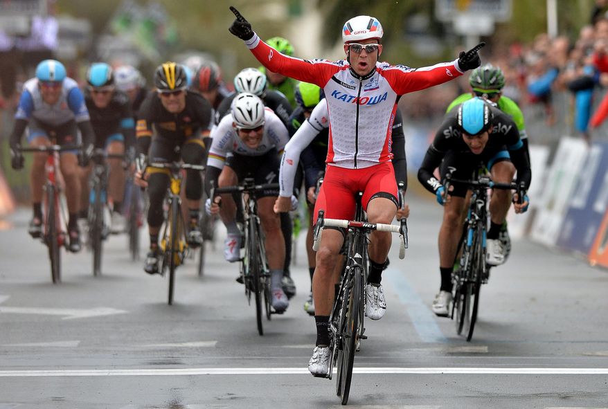 Norway's Alexander Kristoff celebrates as he crosses the finish line to win the Milan-San Remo cycling race, in Sanremo, Italy, Sunday, March 23, 2014. Alexander Kristoff sprinted to victory in the Milan-San Remo classic on Sunday, edging out 2008 winner Fabian Cancellara on a wet and rainy course for the biggest win of his career. Kristoff pulled away in the closing meters to win the 294-kilometer (183 mile) race in 6 hours, 55 minutes, 56 seconds and become the first Norwegian to triumph in the one-day race. (AP Photo/Gian Mattia D'Alberto, Lapresse)