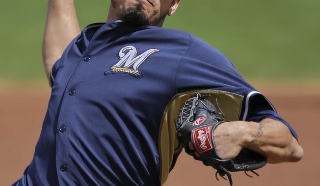 Milwaukee Brewers starting pitcher Matt Garza delivers against the Cincinnati Reds in the first inning of a spring exhibition baseball game Sunday, March 23, 2014, in Goodyear, Ariz. (AP Photo/Mark Duncan)