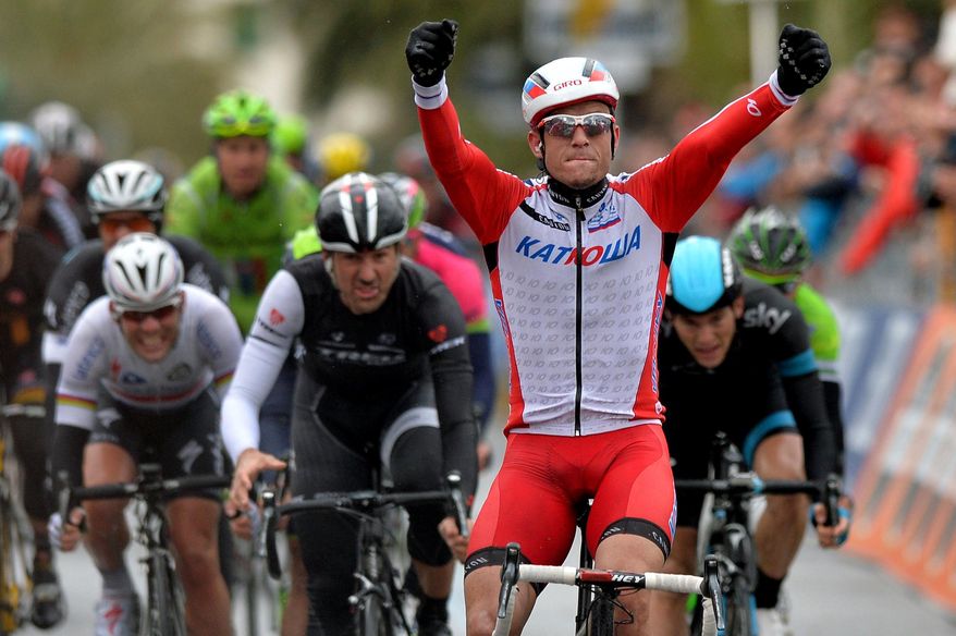 Norway's Alexander Kristoff celebrates as he crosses the finish line to win the Milan-San Remo cycling race, in Sanremo, Italy, Sunday, March 23, 2014. Alexander Kristoff sprinted to victory in the Milan-San Remo classic on Sunday, edging out 2008 winner Fabian Cancellara on a wet and rainy course for the biggest win of his career. Kristoff pulled away in the closing meters to win the 294-kilometer (183 mile) race in 6 hours, 55 minutes, 56 seconds and become the first Norwegian to triumph in the one-day race. (AP Photo/Gian Mattia D'Alberto, Lapresse)