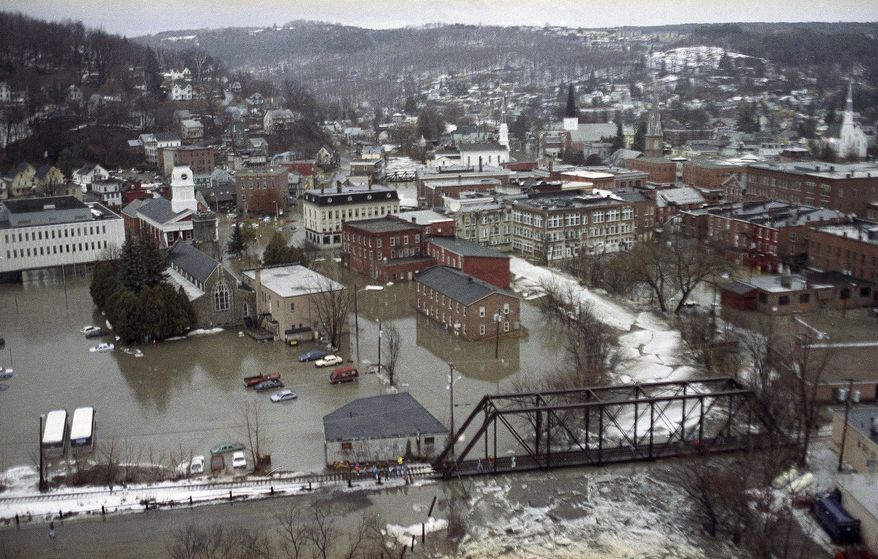 ADVANCE FOR USE MONDAY, MARCH 24, 2014 AT 3 A.M. AND THEREAFTER - FILE - This March 10, 1992 aerial photo shows floodwaters from the North Branch of the Winooski River in downtown Montpelier, Vt. About 2,400 in Vermont, including more than 200 in Montpelier, are among the 1.1 million policyholders nationwide likely to see their federally subsidized flood insurance premiums rise, as government-backed insurance subsidies are scaled back, according to an Associated Press analysis of data from the National Flood Insurance Program. (AP Photo/Jim Cole, File)