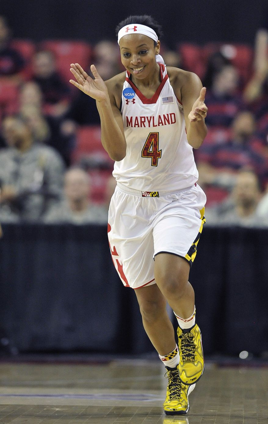 Maryland's Lexie Brown reacts after scoring against Army during the second half of the first round of the NCAA women's college basketball tournament on Sunday, March 23, 2014, in College Park, Md. Maryland won 90-52. (AP Photo/Gail Burton)