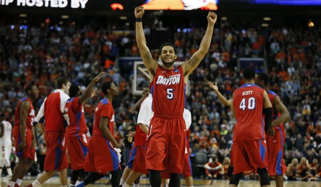 Dayton&#x27;s Devin Oliver celebrates his team&#x27;s victory over Syracuse in the third-round game in the men&#x27;s NCAA college basketball tournament at the First Niagara Center, Saturday, March 22, 2014.  (AP Photo/\Harry Scull Jr./Buffalo News)