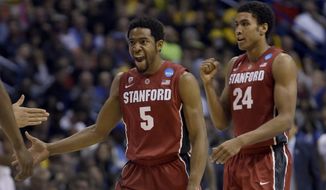 Stanford&#39;s Chasson Randle, left, and Josh Huestis celebrate during the second half of a third-round game against Kansas of the NCAA college basketball tournament Sunday, March 23, 2014, in St. Louis. (AP Photo/Jeff Roberson) 